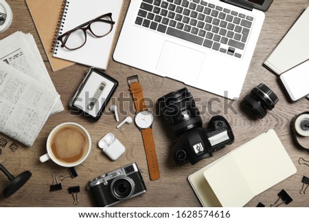 Flat lay composition with equipment for journalist on wooden table