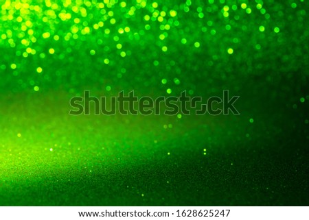 green Sparkling Lights Festive background with texture. Abstract Christmas twinkled bright bokeh defocused