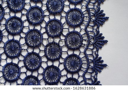 Dark blue crochet lace edge on neutral background