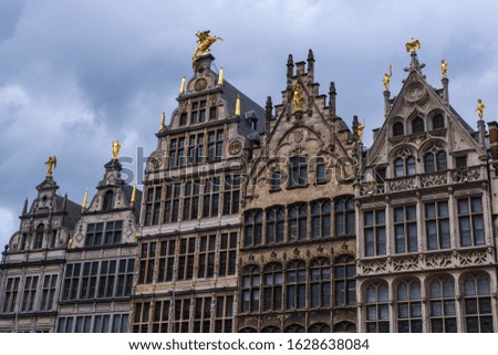 View of a house front at the market square in Antwerp / Belgium with old historical houses under a cloudy sky