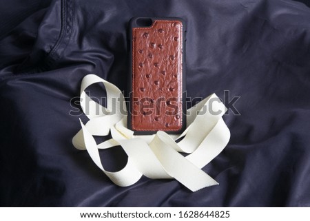 Leather phone case craftsmanship work on the white background.