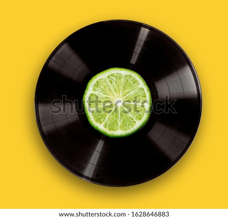 vinyl record on a bright yellow background. The concept of fresh music party