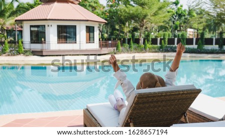 A photo of the hotel's or resort's swimming pool at during the day with young women.