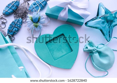 Valentine's Day Gift Concept. blue heart, greeting card and jewelry. invitation. congratulation