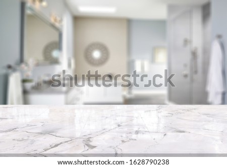 Table Top And Blur Bathroom Of The Background Royalty-Free Stock Photo #1628790238