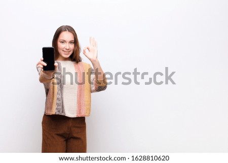 young blonde pretty girl holding a smartphone