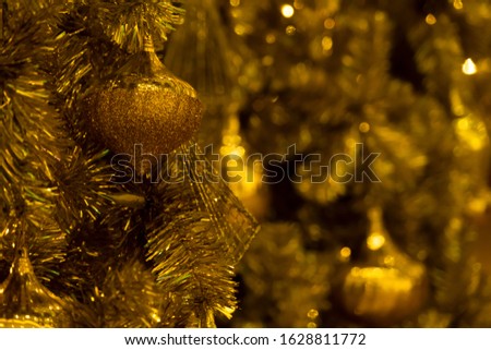 Lighting bulb and decorative golden pine tree Merry Christmas and Happy New Year for abstract background texture, Selective focus
