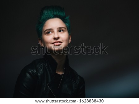 Portrait of a beautiful stylish and fashionable teenager girl with green hair.
