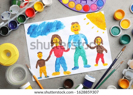 Flat lay composition with child's painting of family on grey table