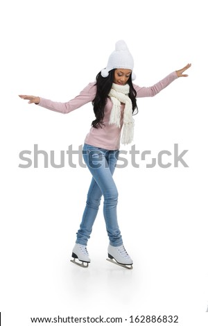 Nice African teenage girl trying to do figure skating. Full length isolated on white 