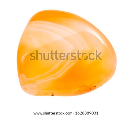 closeup of sample of natural mineral from geological collection - tumbled yellow Carnelian (cornelian) gem stone isolated on white background