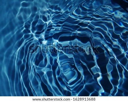 The reflection​ of sunlight​ to​ surface​ blue​ water​ for background. Abstract​ of​ blue water​ for​ blue​ background​