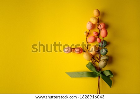 Branch with multi-colored Easter eggs. Little easter decorations. Easter bouquet.