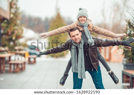Family of father and little kid have fun outdoor at winter day