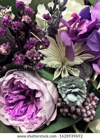 Beautiful bouquet of preserved flowers hydrangea, eucalyptus, purple and white peony roses. Dried flowers. Bouquet of spring flowers.