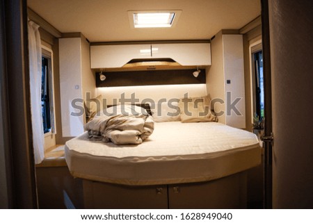 Interior of luxury caravan. Detail photo of coach with equipment.Bedroom and bed