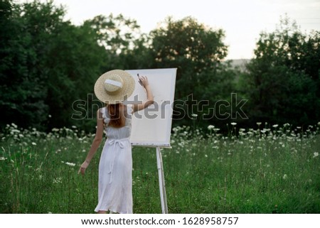 young woman outdoors in a beautiful summer hat