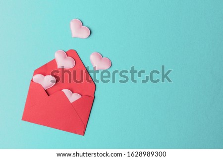 Open red envelope with decorative hearts. Valentines day concept