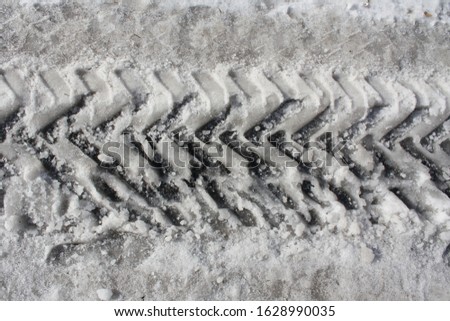 Trace of the car in the snow. Track from tire tread on snow in winter.