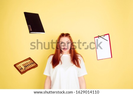 Shocked, deadline. Caucasian young woman's portrait on yellow studio background, too much tasks. How to manage time right. Concept of working, business, finance, freelance, self management, planning.