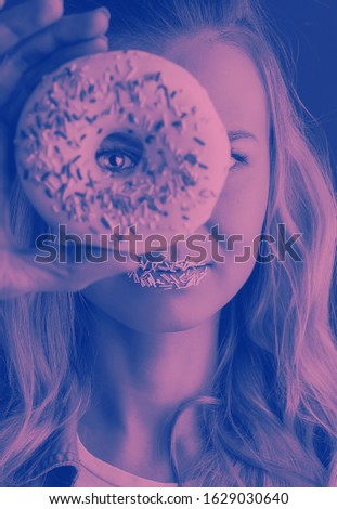 monochromatic photograph of a woman looking at the camera through a hole in a donut
