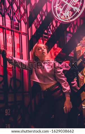 Teenager girl standing leaning on wall isolated on club background nightlife mirror reflection looking aside sassy