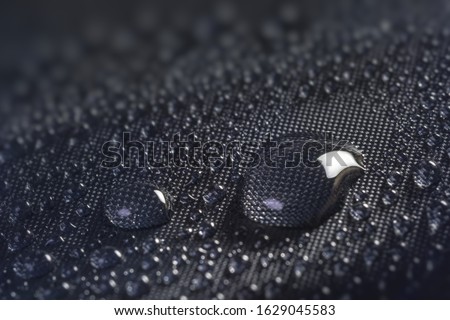 Many water drops on waterproof impregnated fabric. Royalty-Free Stock Photo #1629045583