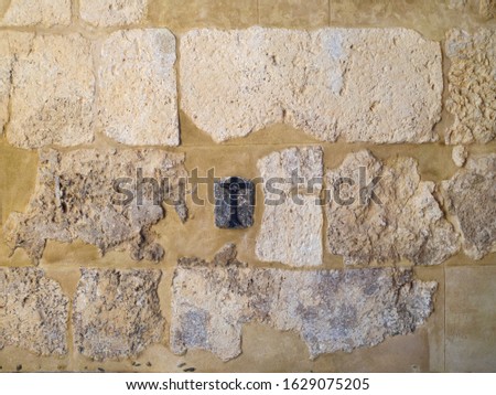 A cross fashioned on a wall in the old city of Cordoba. Spain