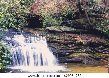 Flowing waterfall with water spilling into small pool stream