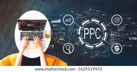 PPC - Pay per click concept with person using a laptop on a white table