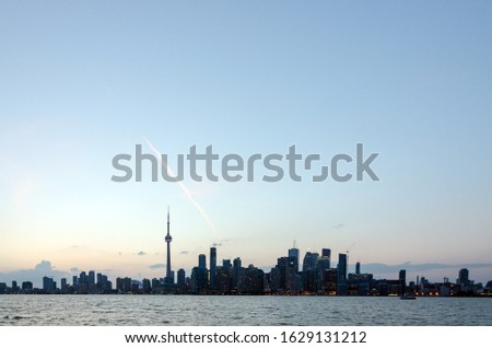 Skyline of Toronto over Ontario Lake at sunset