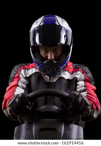 racerwearing red racing suit and blue helmet on a steering wheel Royalty-Free Stock Photo #162914456