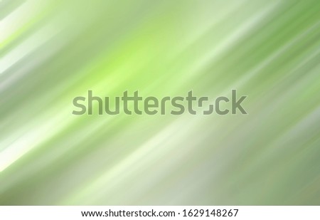 Green colorful blurred gradient background. Mixed motion texture. Abstract diagonal lines wallpaper