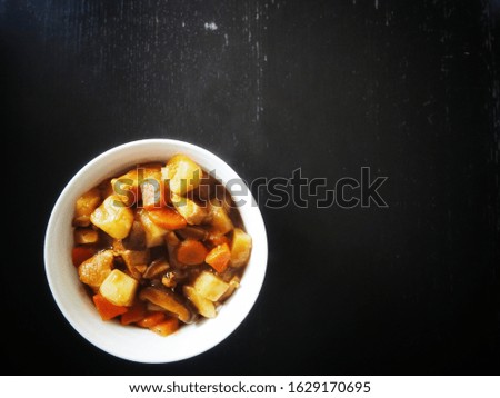 Homemade stew on a dark table (left under side)