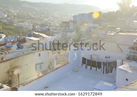 Local hanging their laundry on the rooftop, at Chefchaouen.