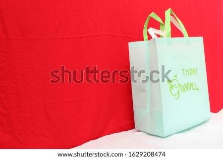 ECO Friendly Think Green Bag on White Table against red color background. Say No to Plastic. Save earth. World Environment Day Concept