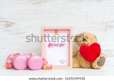 Mockup picture frame for fitness healthy lifestyle with valentines day & love season background concept. Mock up photo frame with pink dumbbells, measurement tape and cute bear doll and red heart.