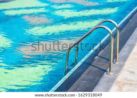Stair around outdoor swimming pool in hotel resort for travel vacation