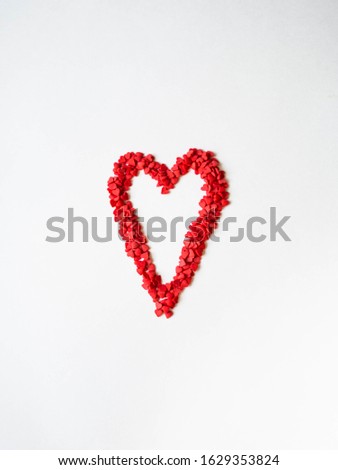 Red sugar sprinkles heart. Sugar sprinkle hearts, decoration for cake and bakery, a symbol of love on valentines day on white background. Top view
