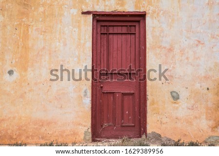 Red door on old abandoned building