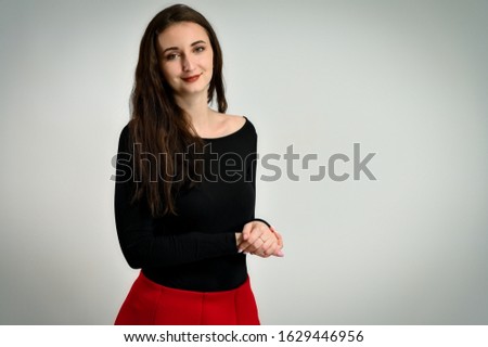 Photo of a pretty young brunette woman with a smile with good makeup on a white background. Concept girl talking in front of the camera with emotions.