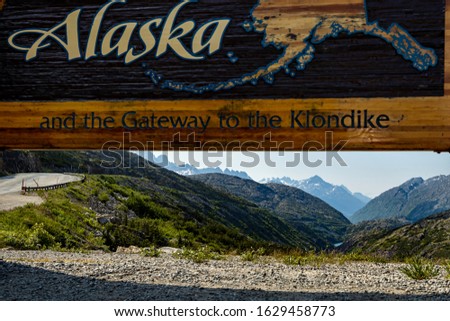 The welcome sign of Alaska at the border of Canada