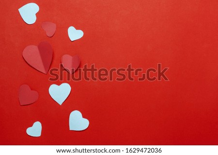 Table top view aerial image of decoration valentine's day background concept.Flat lay essential items colorful love shape paper cut  on modern rustic red wallpaper.space for mock up creative design.