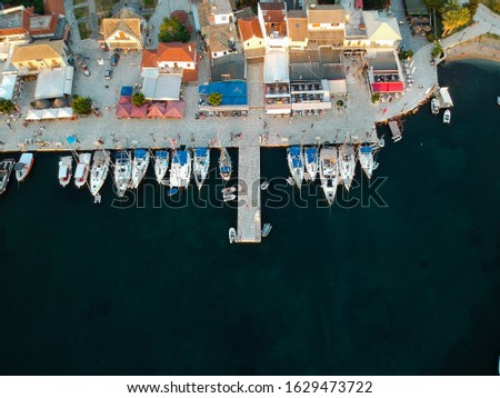 sivota aerial photo of bay dock harbor lighthouse speedboats and luxury yachts and people walk in the bay of sivota town near perdika igoumenitsa preveza parga epirus greece