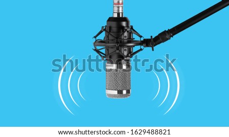 Studio microphone for recording podcasts isolated on a bright blue background