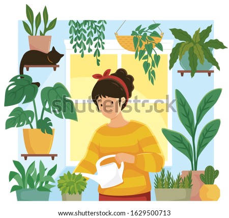 Young woman watering plants in an indoor home garden 