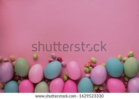 Colorful easter eggs on a colored uniform background. Template for text, poster, poster, advertisement.