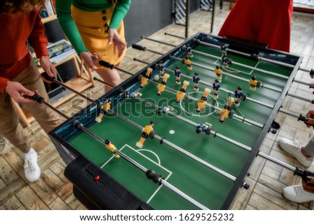 Killing boredom. Cropped photo of young people playing table soccer in the office. Having fun. Office activities Royalty-Free Stock Photo #1629525232