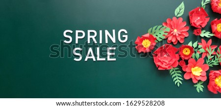 Spring sale. With red paper flowers and green leaves