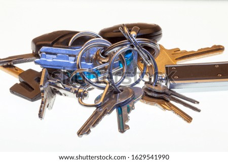 studio shot of a bunch of keys on a pile from every day pocket on white background